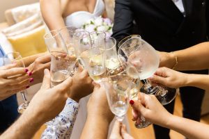 photo of wedding day drinks toasting the bride and groom