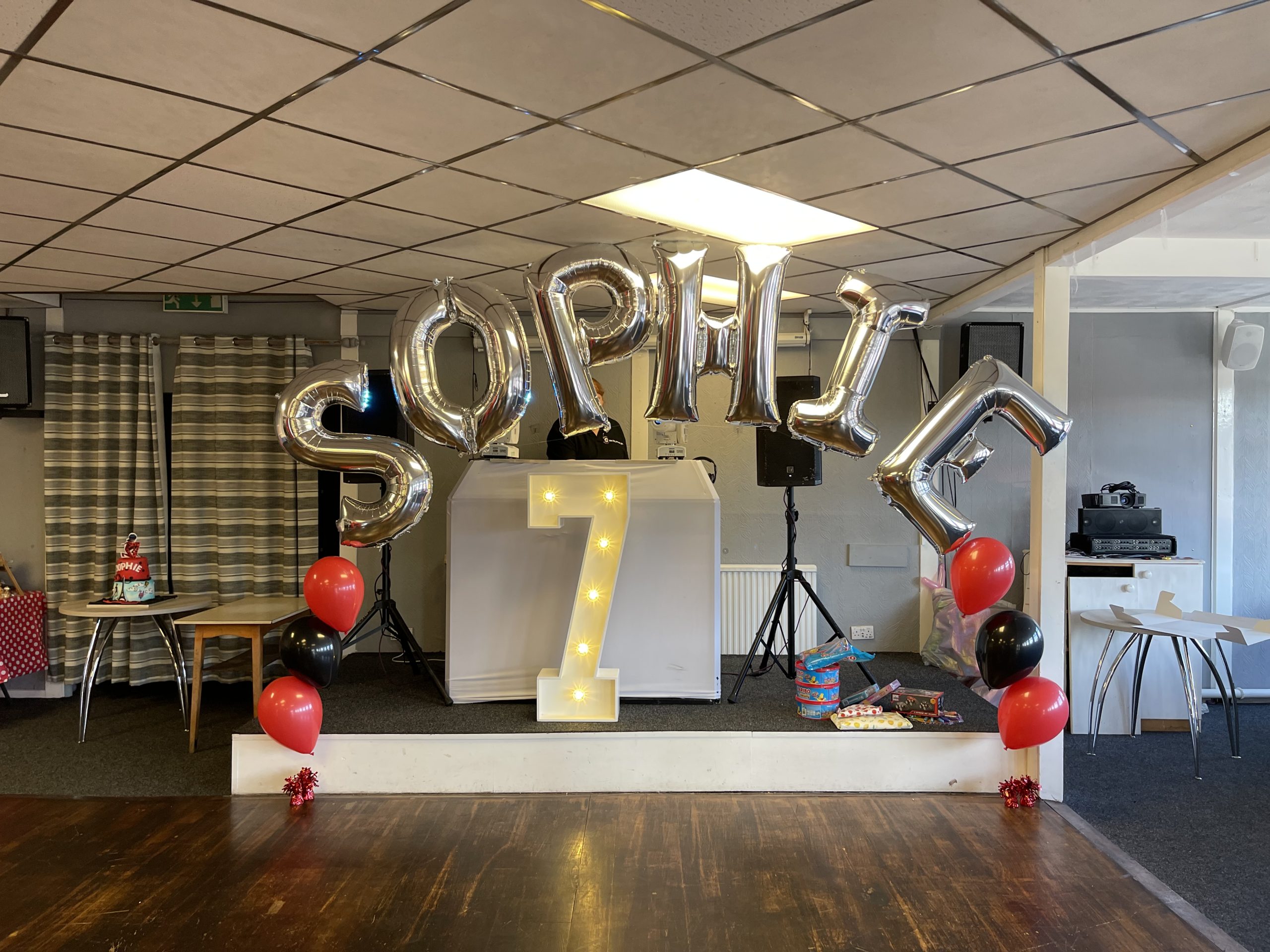 Balloon display with foil letters spelling a children's birthday name