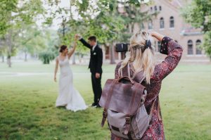 Wedding photographer taking pictures of a bride and groom