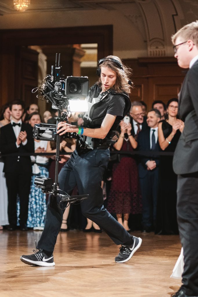 videographer moving with camera at a wedding