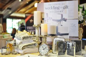 wedding gift table set at wedding with sliver clock, candle sticks and candles, white and grey towels